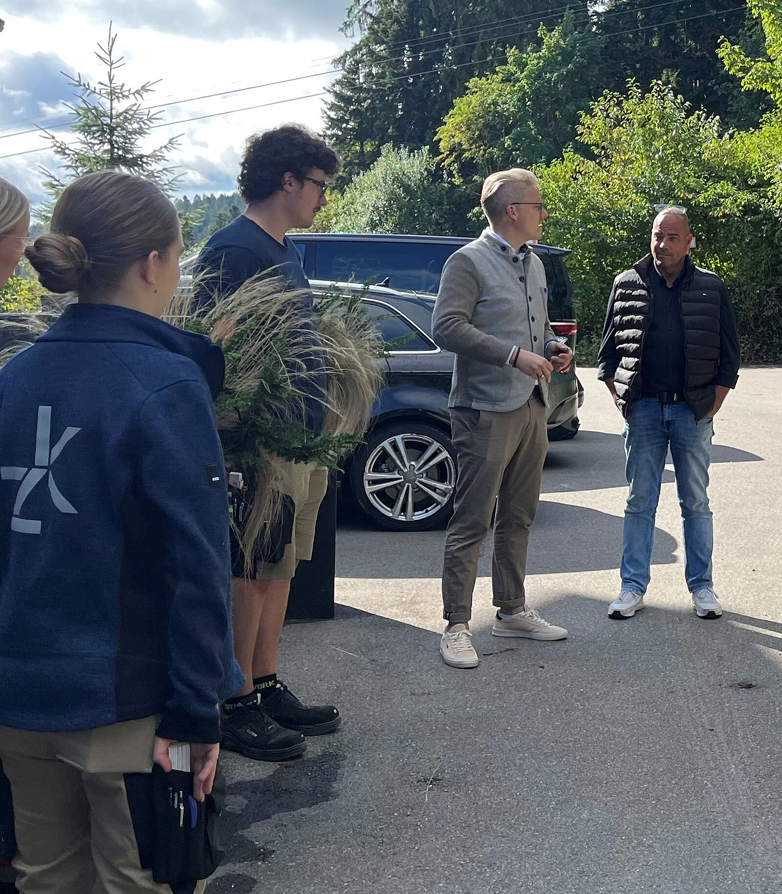 vier Personen stehen im Kreis und einer spricht